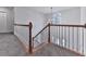 Staircase with white railings, wooden handrail and a decorative chandelier at 405 Sable Trace Cv, Acworth, GA 30102