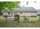 Home's backyard with play area, outdoor seating, grass, and full wood fence, is great for entertaining at 420 Bear Cub Path, Social Circle, GA 30025