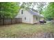 This home has a spacious backyard with grass, wood fence, and plenty of room to play at 420 Bear Cub Path, Social Circle, GA 30025