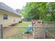 Fenced backyard with play equipment, perfect for activities and secure outdoor enjoyment at 420 Bear Cub Path, Social Circle, GA 30025