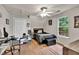 This bedroom features a window, closet, ceiling fan, and flexible workspace area with modern desk at 420 Bear Cub Path, Social Circle, GA 30025
