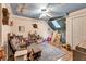 This stylish bedroom features a ceiling fan and colorful sky-themed ceiling mural at 420 Bear Cub Path, Social Circle, GA 30025