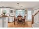 Bright dining room features hardwood floors, a dining table and charming light fixture at 420 Bear Cub Path, Social Circle, GA 30025