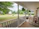 Relaxing front porch view with rocking chairs, greenery, and a glimpse of the neighborhood at 420 Bear Cub Path, Social Circle, GA 30025