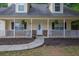 Close-up of the cozy front porch with decorative plants and charming architectural details at 420 Bear Cub Path, Social Circle, GA 30025