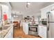 Kitchen features stainless steel appliances, granite countertops, and a view of an adjacent room at 420 Bear Cub Path, Social Circle, GA 30025