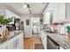 Well-lit kitchen featuring stainless steel appliances, granite countertops, and a view of laundry area at 420 Bear Cub Path, Social Circle, GA 30025