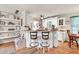 Stylish kitchen with a breakfast bar, white cabinets, and open layout to the living room at 420 Bear Cub Path, Social Circle, GA 30025