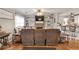 Cozy living room featuring a stone fireplace, comfortable seating, and hardwood floors at 420 Bear Cub Path, Social Circle, GA 30025