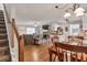 Spacious living area with a stone fireplace, dining area, and seamless flow to the kitchen at 420 Bear Cub Path, Social Circle, GA 30025