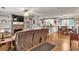 Open-concept living room with a stone fireplace, built-in shelves, and views into the kitchen at 420 Bear Cub Path, Social Circle, GA 30025