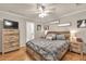 This main bedroom features a tv, wooden furniture and an ensuite bathroom entrance at 420 Bear Cub Path, Social Circle, GA 30025