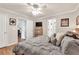 Bright main bedroom featuring a tv, wooden furniture and multiple closets at 420 Bear Cub Path, Social Circle, GA 30025