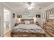Cozy main bedroom with neutral tones, rustic wood furniture, and ensuite bathroom entrance at 420 Bear Cub Path, Social Circle, GA 30025