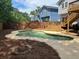 Backyard featuring kidney-shaped pool, wooden fence, and deck, creating an outdoor oasis at 4811 Nevilly Way, Marietta, GA 30066