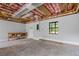 Unfinished basement with exposed ceiling, concrete floor, and a window for natural light at 4811 Nevilly Way, Marietta, GA 30066