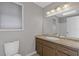 Bathroom featuring a granite counter, vanity, mirror, and a toilet at 4811 Nevilly Way, Marietta, GA 30066