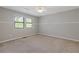Bedroom featuring two windows that provide lots of natural light, neutral paint and carpet at 4811 Nevilly Way, Marietta, GA 30066