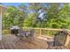 Inviting deck with outdoor seating and grill, perfect for entertaining amidst lush greenery at 4811 Nevilly Way, Marietta, GA 30066