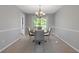 Dining room features carpeted floor, neutral paint, chandelier and a view to a deck at 4811 Nevilly Way, Marietta, GA 30066