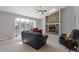 Living room featuring a stone fireplace, carpeted floor and lots of natural light at 4811 Nevilly Way, Marietta, GA 30066