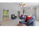 Spacious living room featuring neutral paint, carpet, fan and comfortable furnishings at 4811 Nevilly Way, Marietta, GA 30066