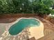 Aerial view of a kidney-shaped pool, fenced yard, with plenty of privacy provided by mature trees at 4811 Nevilly Way, Marietta, GA 30066