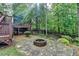 Backyard fire pit with deck overlooking natural surroundings, perfect for outdoor enjoyment at 5195 Stefan Ridge Way, Buford, GA 30519
