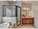 Modern bathroom featuring a glass-enclosed shower, soaking tub, granite counters, and a wooden vanity at 5195 Stefan Ridge Way, Buford, GA 30519