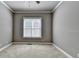 Neutral bedroom featuring a window, neutral paint, plush carpeting, and trim at 5195 Stefan Ridge Way, Buford, GA 30519