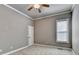 Neutral bedroom featuring a window, neutral paint, plush carpeting, and trim at 5195 Stefan Ridge Way, Buford, GA 30519