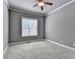 Neutral bedroom featuring a window, neutral paint, plush carpeting, and trim at 5195 Stefan Ridge Way, Buford, GA 30519