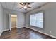Bedroom featuring wood look floors, closet, drop ceiling and neutral colored paint at 5195 Stefan Ridge Way, Buford, GA 30519