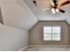 Bright bedroom with vaulted ceilings, neutral paint, a large window, carpeted floors and ceiling fan at 5195 Stefan Ridge Way, Buford, GA 30519