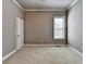 Neutral bedroom featuring a window, neutral paint, plush carpeting, and trim at 5195 Stefan Ridge Way, Buford, GA 30519