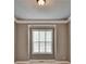 Cozy bedroom features a window bringing in natural light and neutral colored walls at 5195 Stefan Ridge Way, Buford, GA 30519