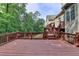Back deck with steps leading down to the lawn and trees at 5195 Stefan Ridge Way, Buford, GA 30519