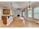 Open concept kitchen and dining area with fireplace and hardwood floors at 5195 Stefan Ridge Way, Buford, GA 30519