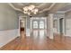 Elegant dining room with a decorative chandelier, and hardwood floors at 5195 Stefan Ridge Way, Buford, GA 30519