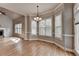 Sunlit dining area with hardwood floors and a chandelier at 5195 Stefan Ridge Way, Buford, GA 30519