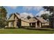 Stately home with a stone and siding exterior, lush lawn, and mature trees at 5195 Stefan Ridge Way, Buford, GA 30519