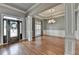 Grand foyer featuring hardwood floors, elegant chandelier, and custom trim work at 5195 Stefan Ridge Way, Buford, GA 30519