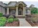 Inviting brick home entrance with a covered porch and landscaped walkway at 5195 Stefan Ridge Way, Buford, GA 30519