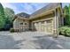 Attached three-car garage providing ample parking and storage space at 5195 Stefan Ridge Way, Buford, GA 30519