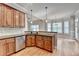 Kitchen featuring stainless steel appliances, granite countertops, and wooden cabinets at 5195 Stefan Ridge Way, Buford, GA 30519