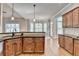 Traditional kitchen features wood cabinets, granite countertops, and an open floor plan at 5195 Stefan Ridge Way, Buford, GA 30519