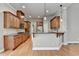 Beautiful kitchen with stainless steel appliances and granite counters with pendant lighting at 5195 Stefan Ridge Way, Buford, GA 30519