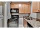 Kitchen featuring appliances, granite countertops and light wooden cabinets at 5195 Stefan Ridge Way, Buford, GA 30519