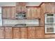 Gourmet kitchen showcases stainless steel appliances, wood cabinets, and granite countertops at 5195 Stefan Ridge Way, Buford, GA 30519