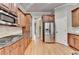 Modern kitchen with stainless appliances, stone backsplash, and wooden cabinetry at 5195 Stefan Ridge Way, Buford, GA 30519